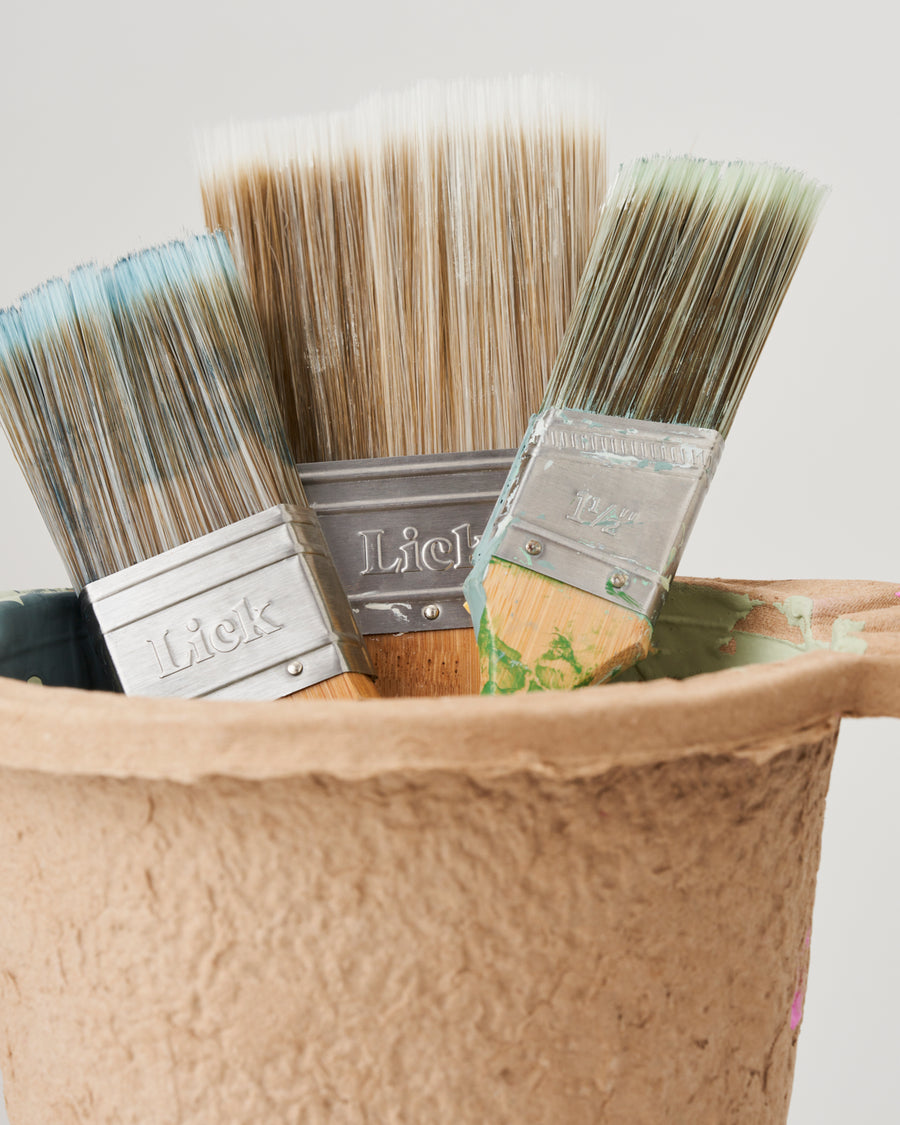 Lick paint brushes in paint kettle